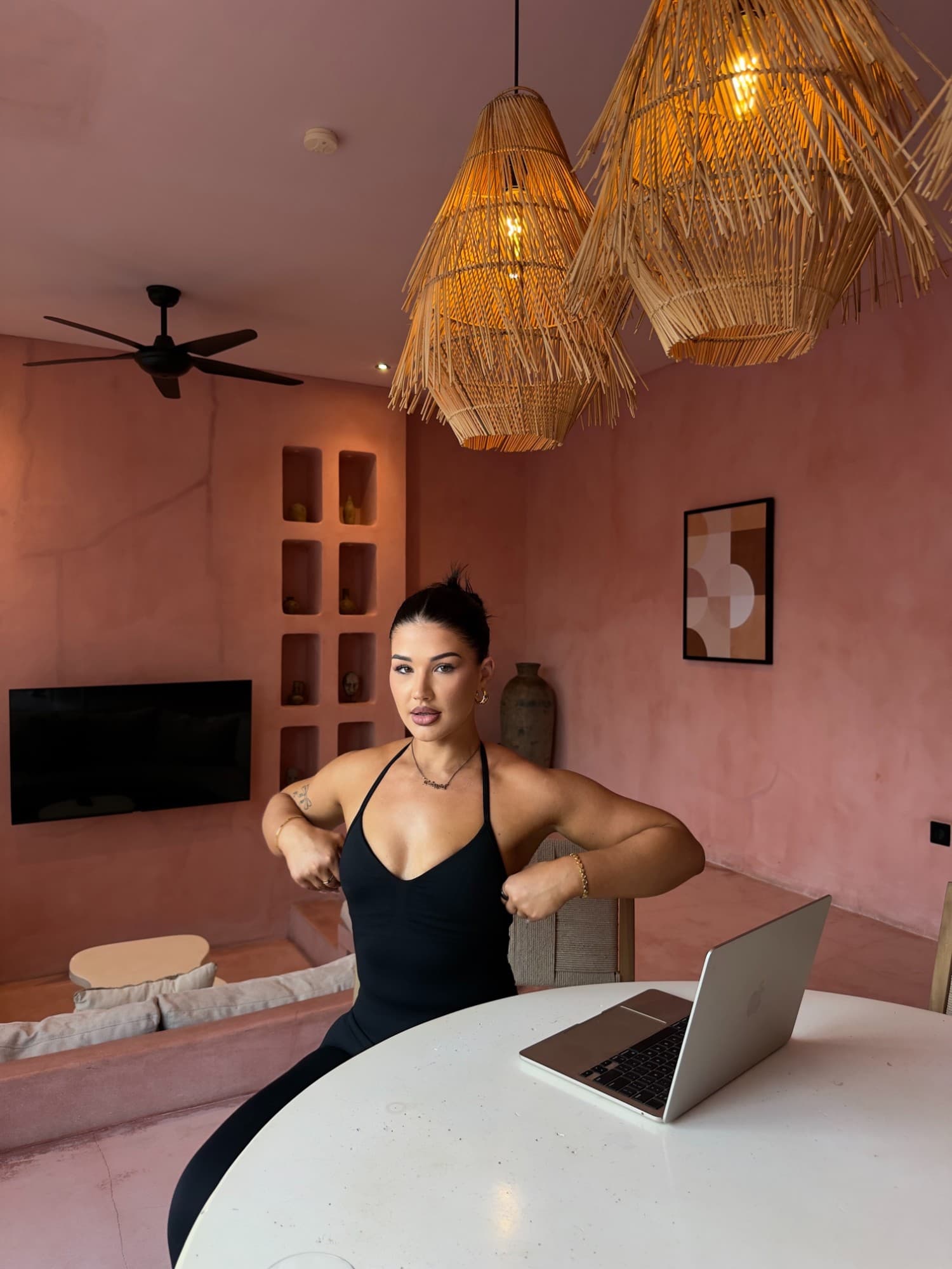 Amber sitting at a table with her laptop